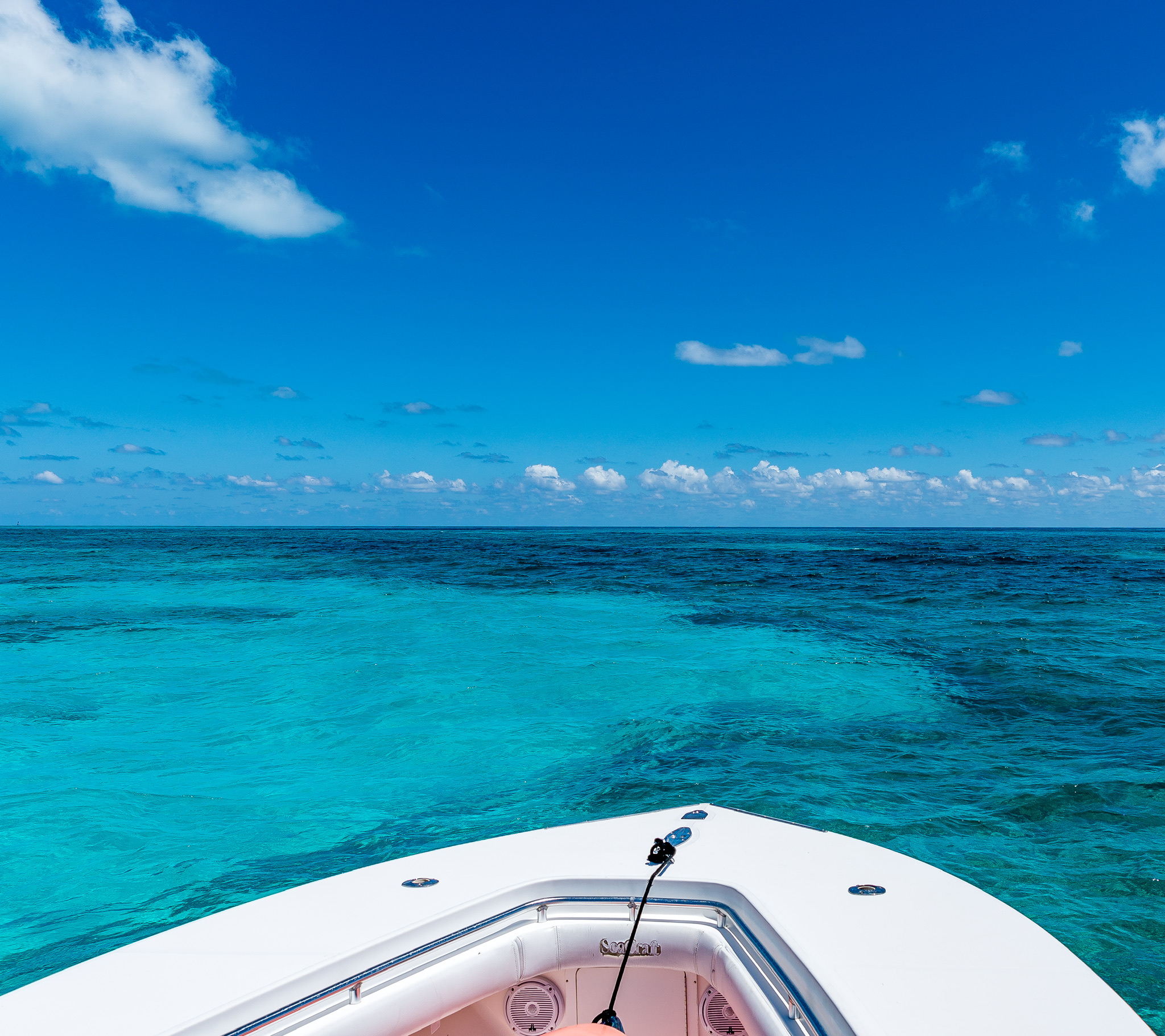 View from the bow of the M&M SeaCraft looking out over crystal clear turquoise Keys water