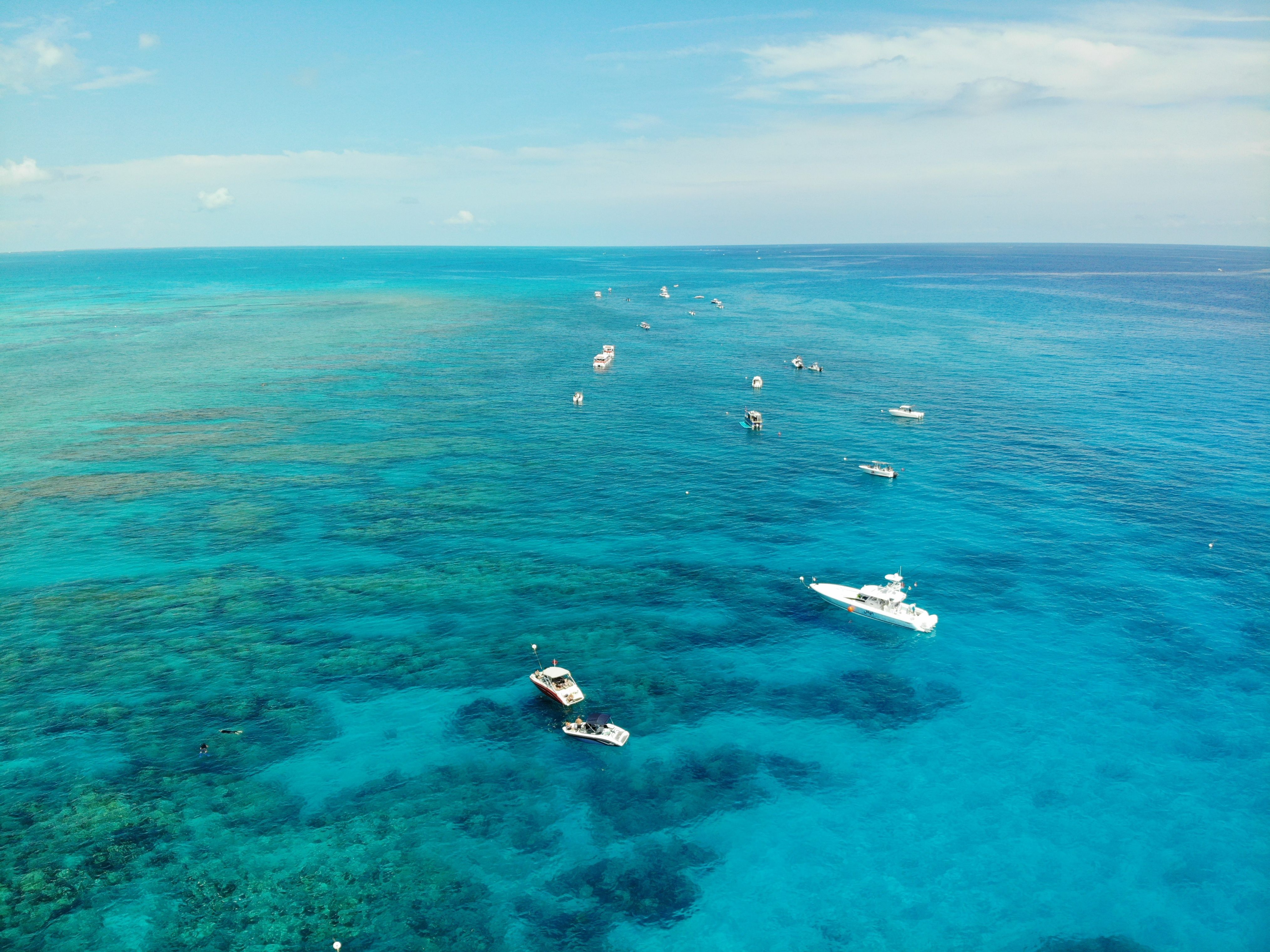 Aerial view of boats fishing over the crystal clear turquoise reef in the Florida Keys